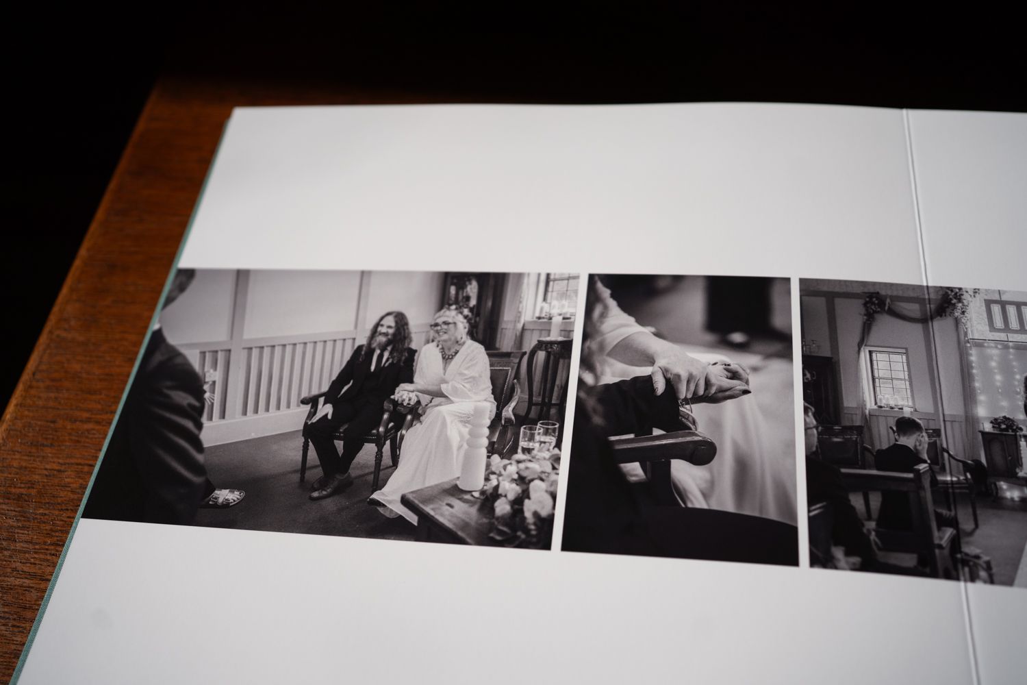 Black and white wedding photographs arranged in a photo album showing various candid moments.