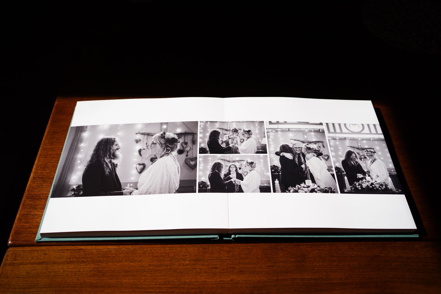 A wedding album displays a series of black and white candid photographs spread across two pages.