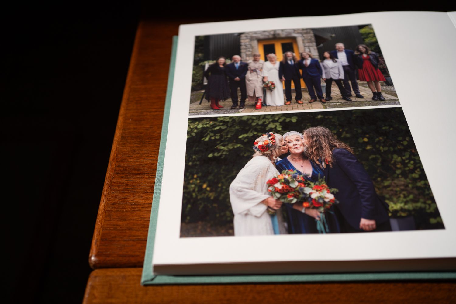 Two wedding photos in a photo album showing a group shot and a close-up with flowers.