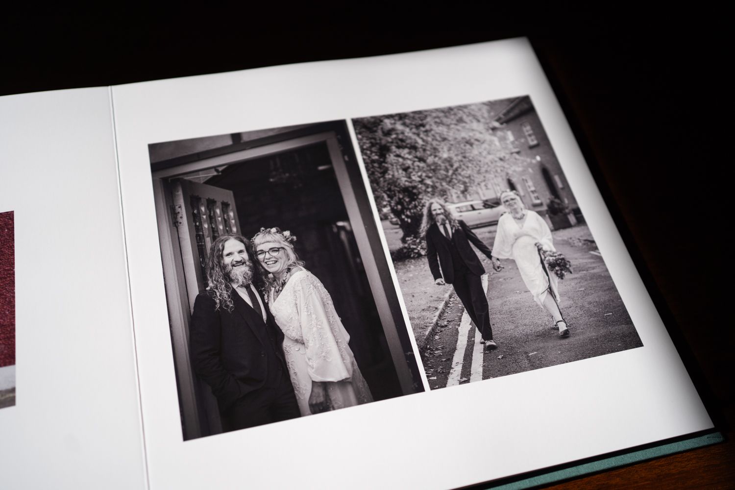 Black and white photograph showing two vintage photos displayed in an album or photo book.
