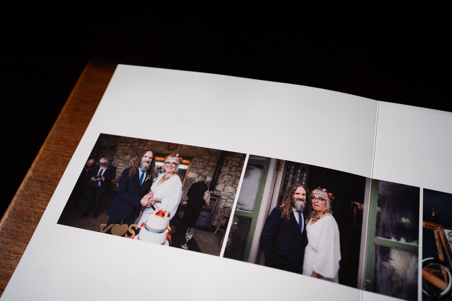 Wedding photo album displaying formal portraits in an elegant indoor setting.
