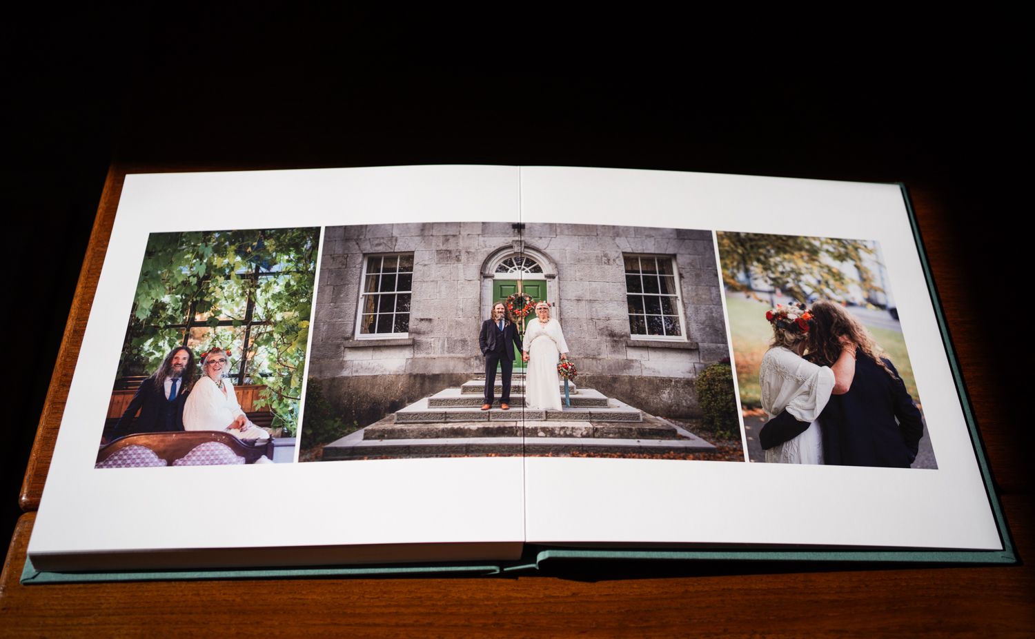 A wedding photo album displays three photos spread across pages showing couples on steps and outdoor settings.