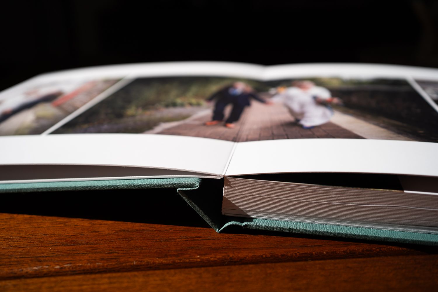 An open photo album showing the binding and a partially visible photograph inside.