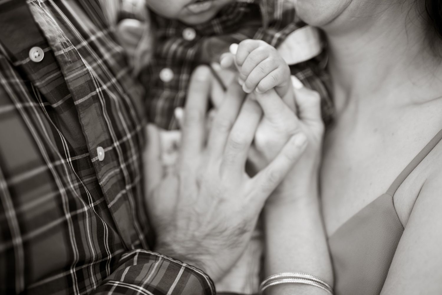 Close-up black and white photos showing tender moments between a couple.
