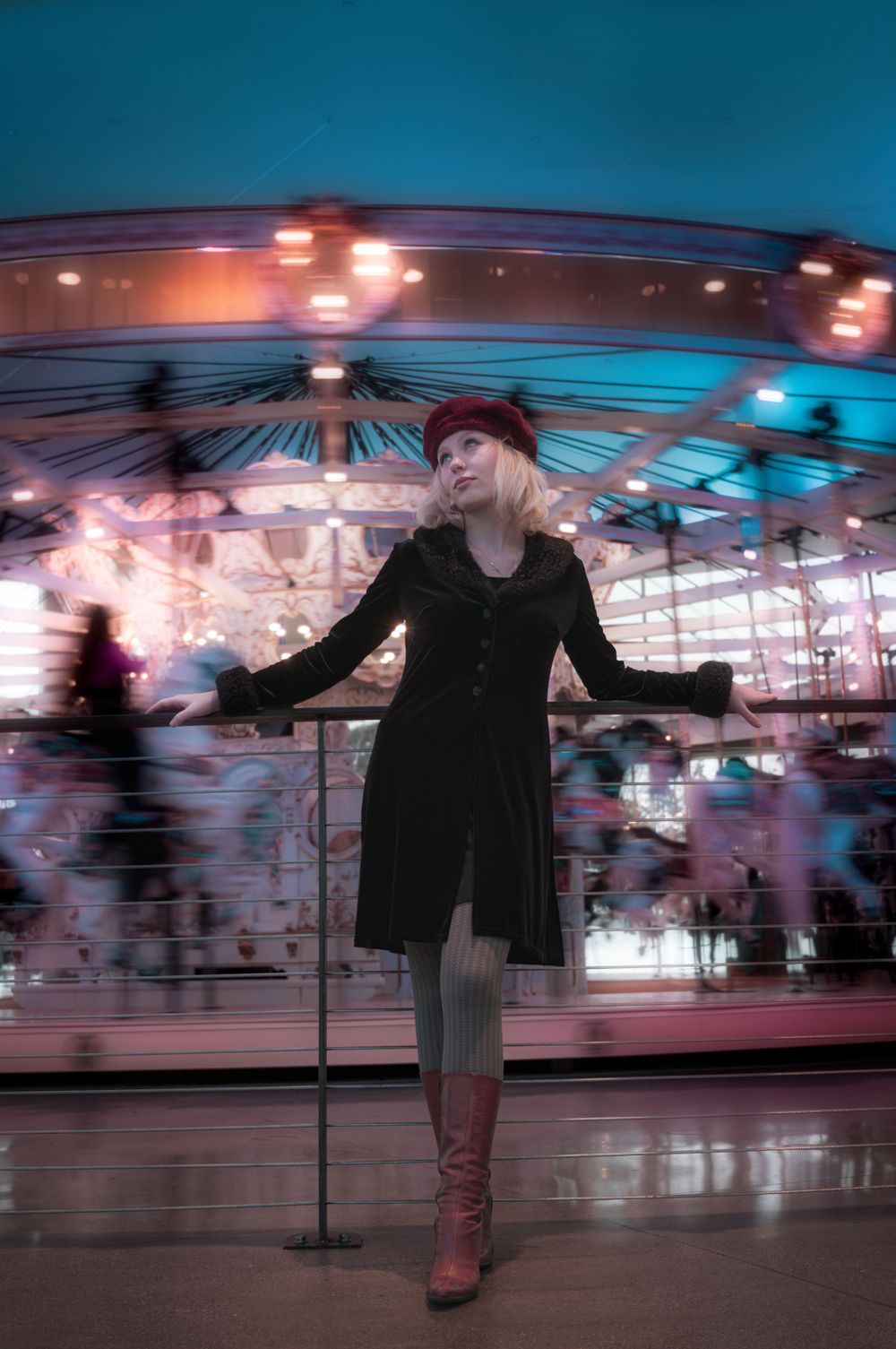 A model standing in front of the Looff Carousel in Riverfront Park in Spokane Washington by Jessica Rae Photography.