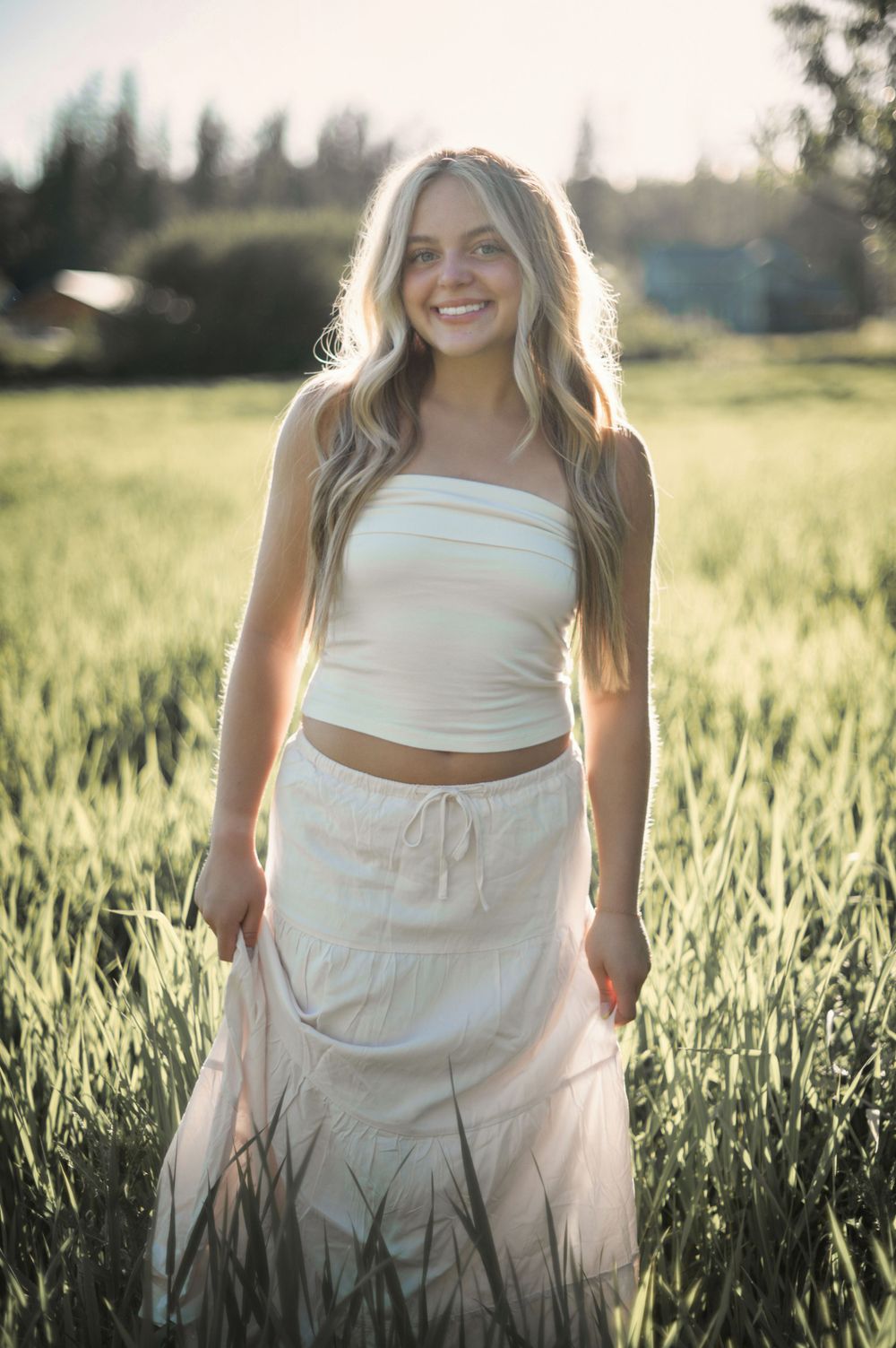 A high school senior during golden hour in all white posing for a senior photoshoot. Taken in Spokane Washington by Jessica Rae Photography.