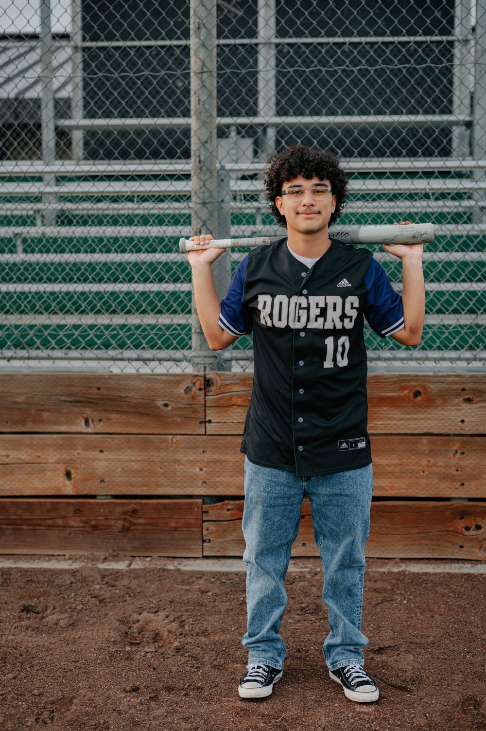 A senior at rogers high school posing for a senior photo in his jersey taken in Spokane Washington by Jessica Rae Photography.