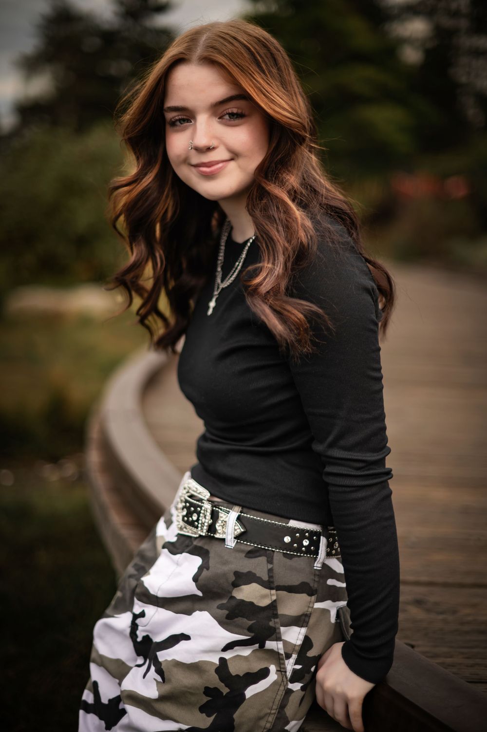 A high school senior posing for a photo in riverfront park in spokane washington. By Jessica Rae Photography.