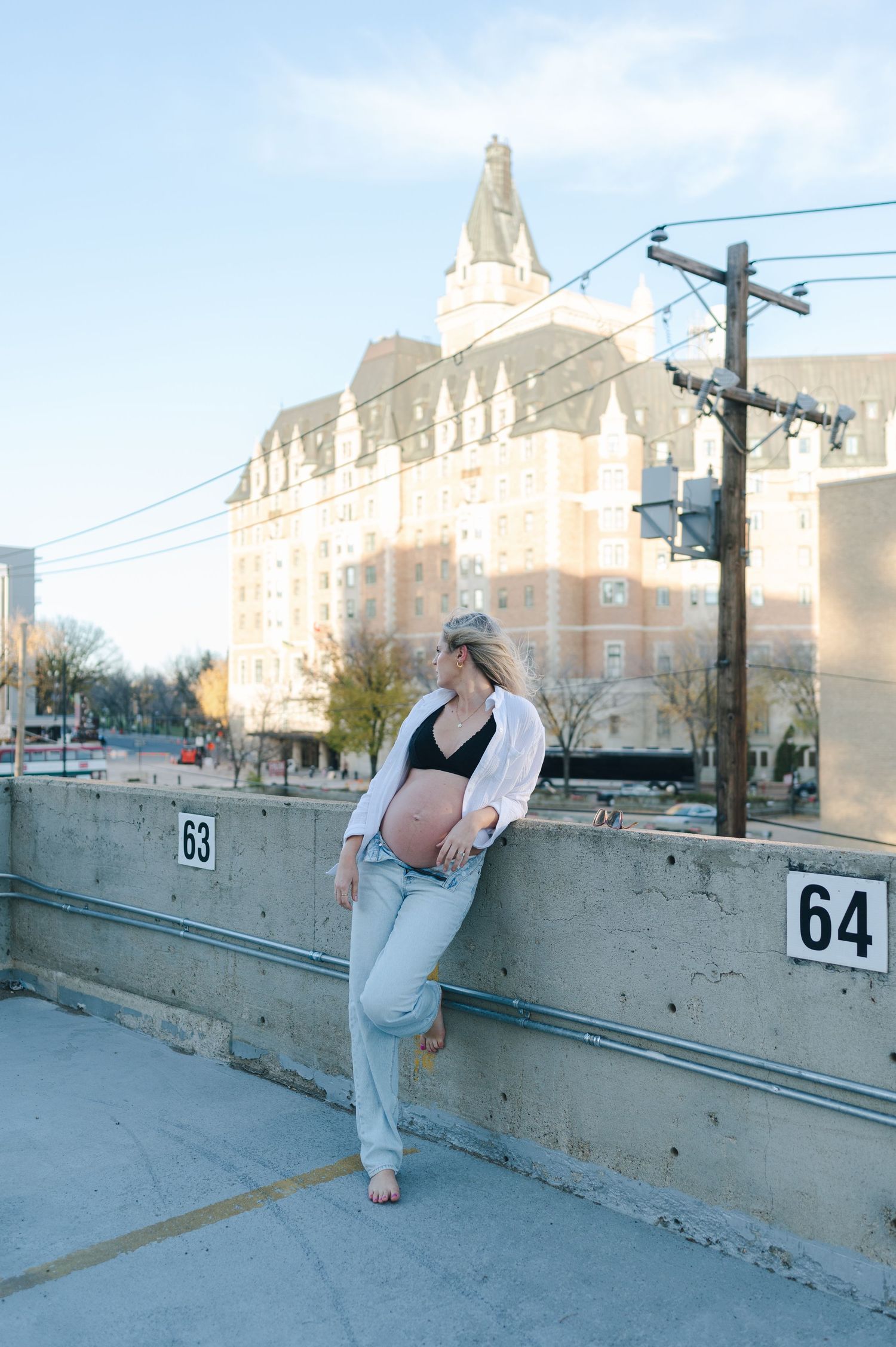 A maternity photo shoot in front of a historic building with ornate architecture.