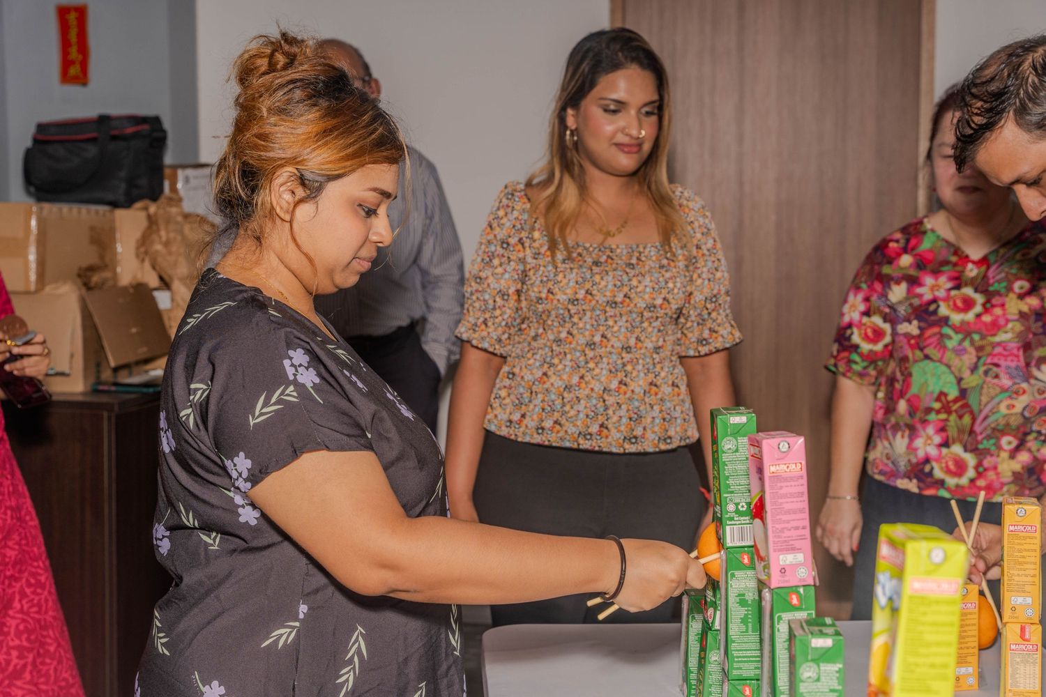 People arranging beverages and refreshments at a celebration event.