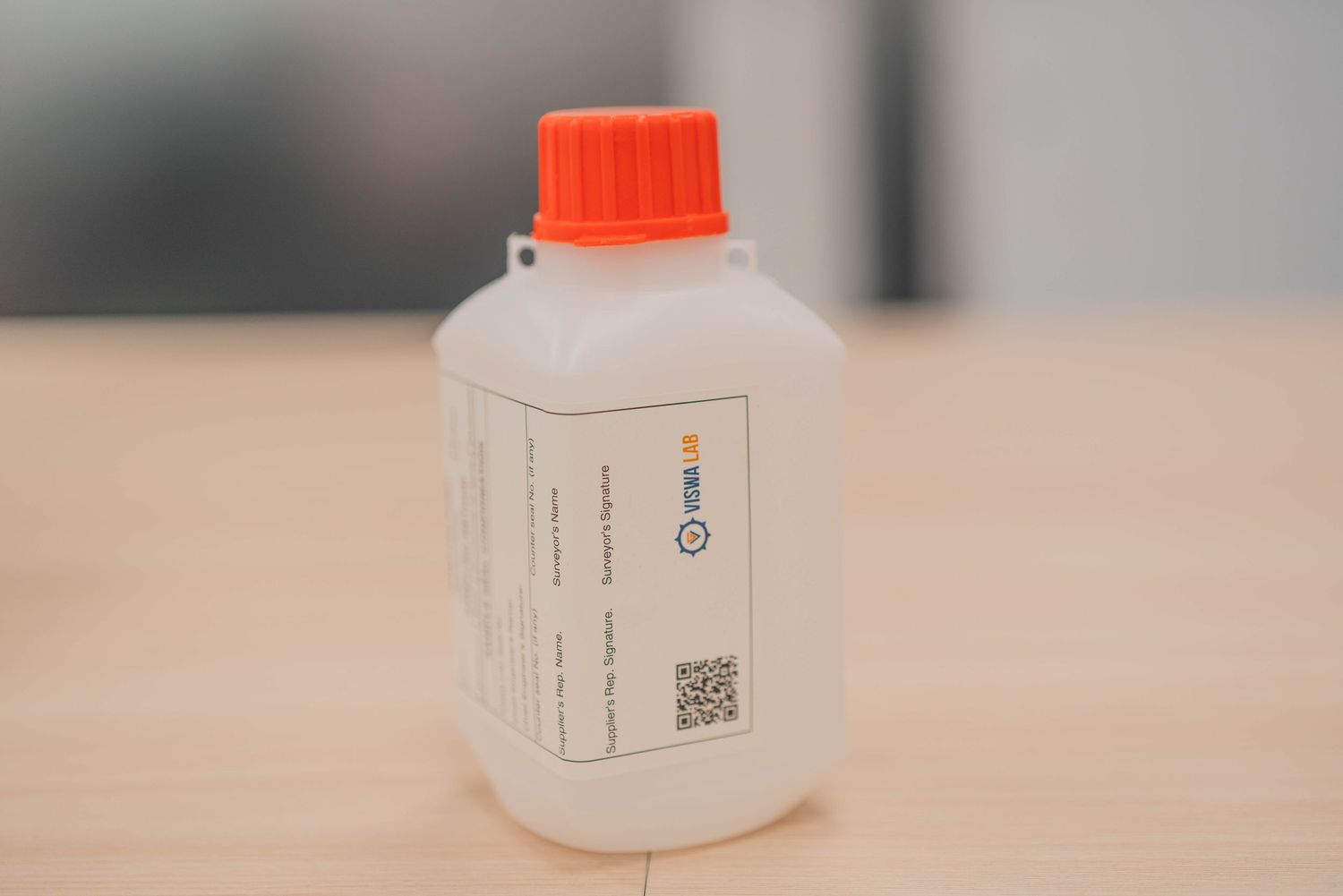 Laboratory bottle with orange cap containing medical or scientific liquid.