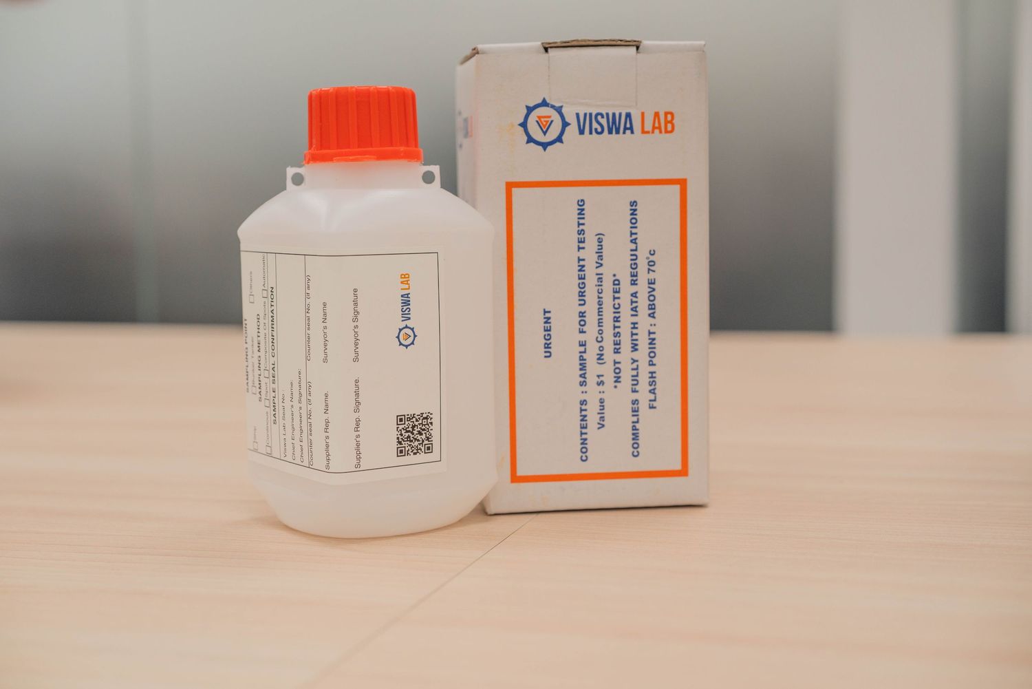 Medical supply bottle and package from Viswa Lab on wooden surface.