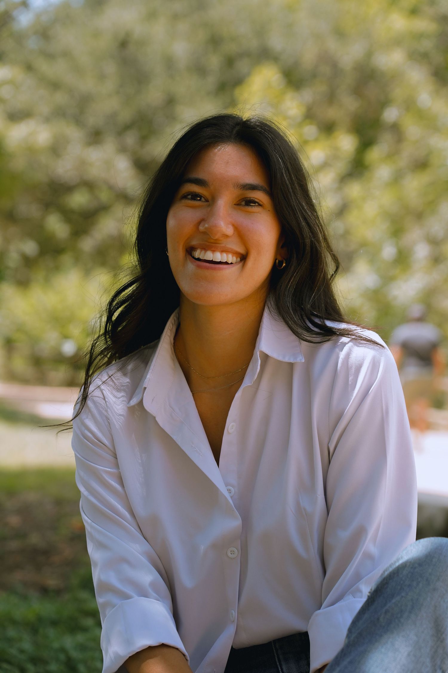 A casual outdoor portrait with natural laughter .