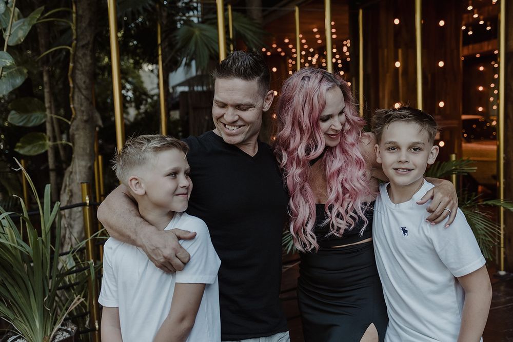 Close family portrait with parents and two sons during luxury photoshoot at Residencia Art Project, Playa del Carmen.