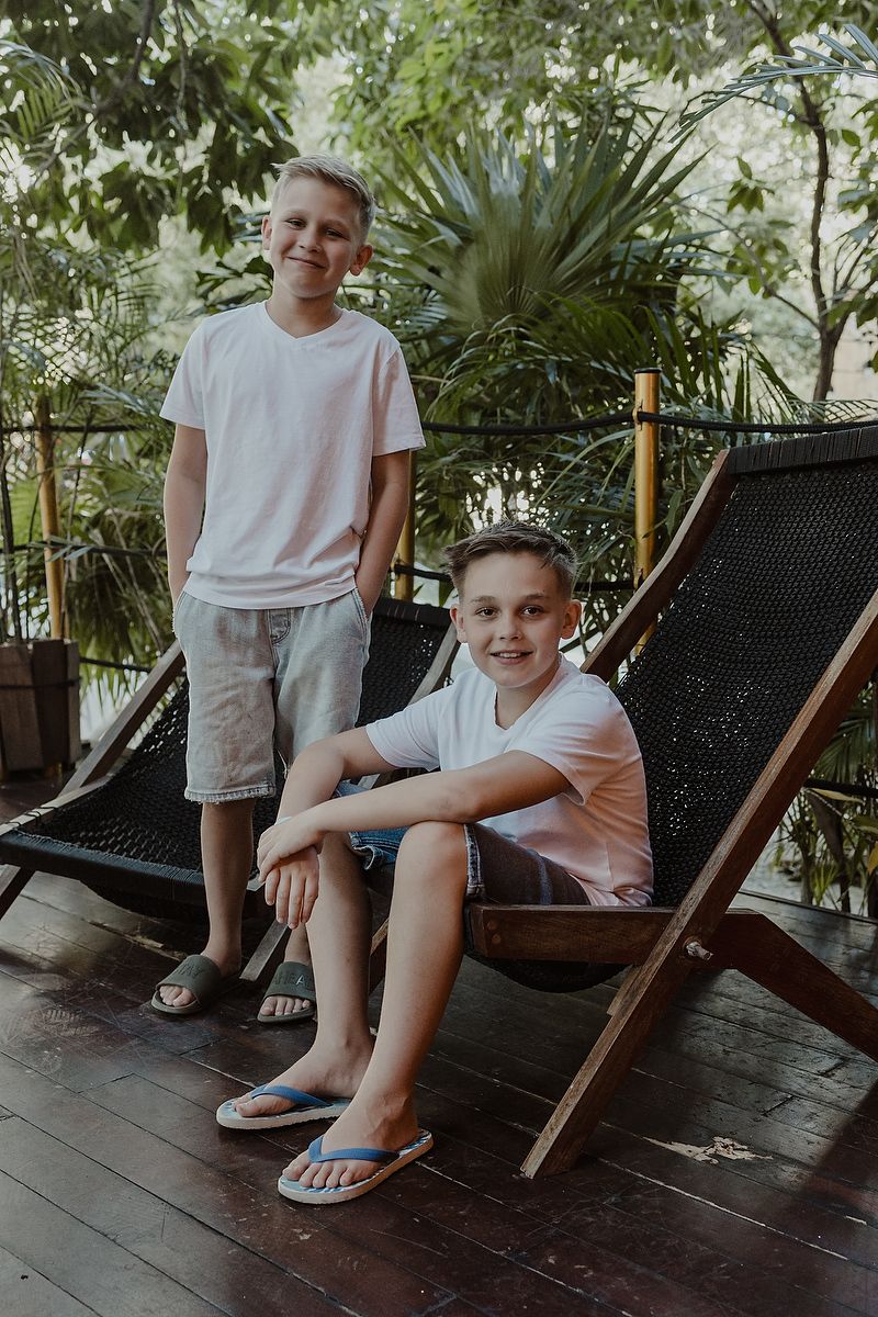 Editorial portrait of boy smiling at luxury family photoshoot in Playa del Carmen.