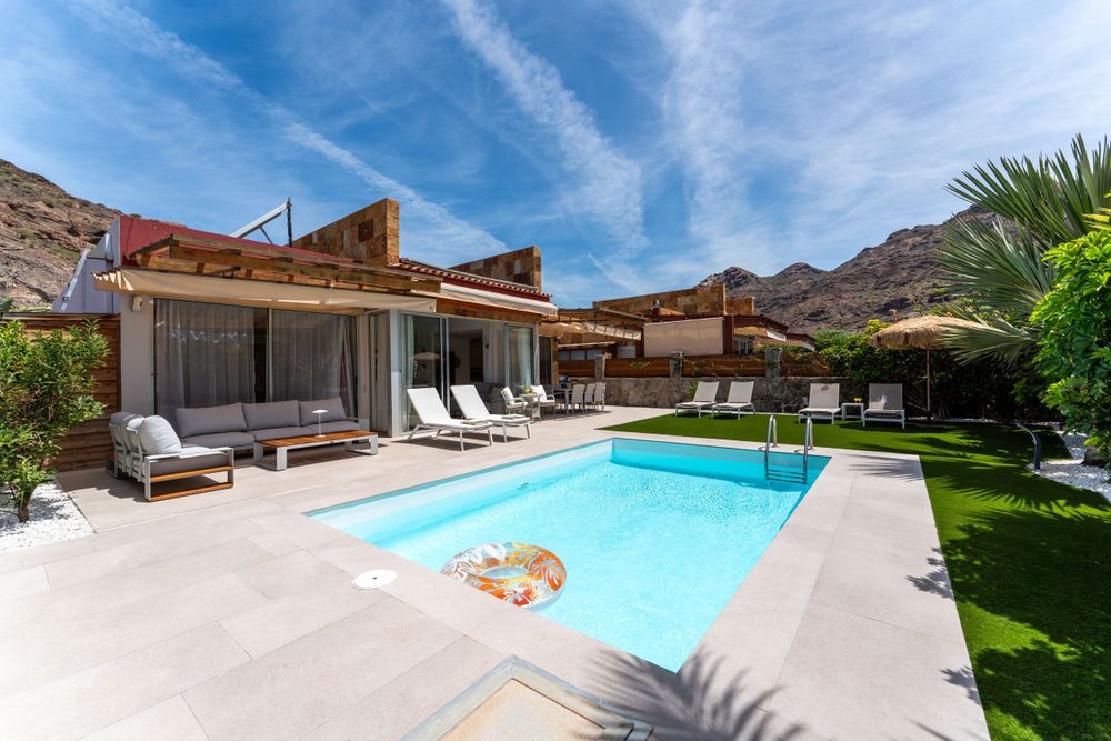Contemporary desert home featuring a rectangular pool and patio with mountain views.