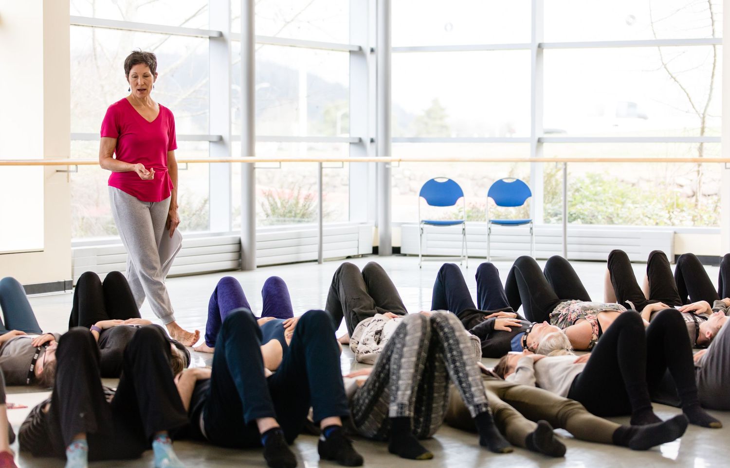 Students laying on floor participating in mindfulness or relaxation exercise during a classroom session.
