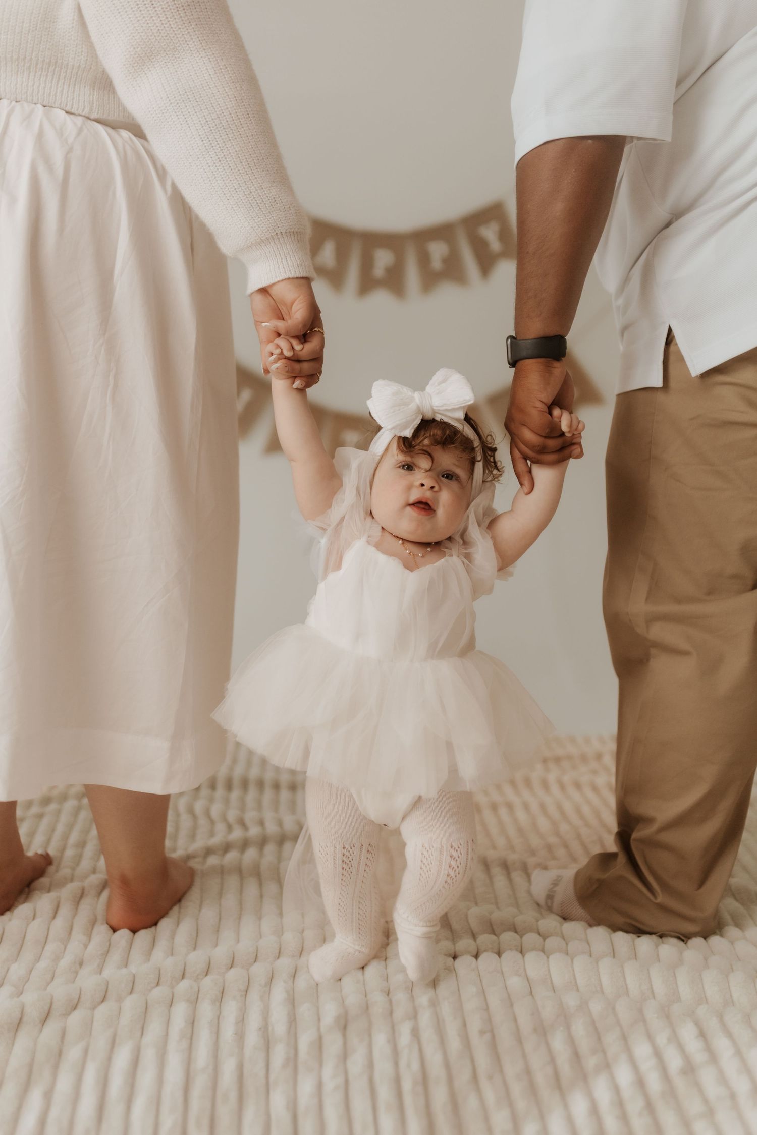 Close-up shots of small feet and hands during an intimate family photo session on textured carpet in Richlands NC studio.