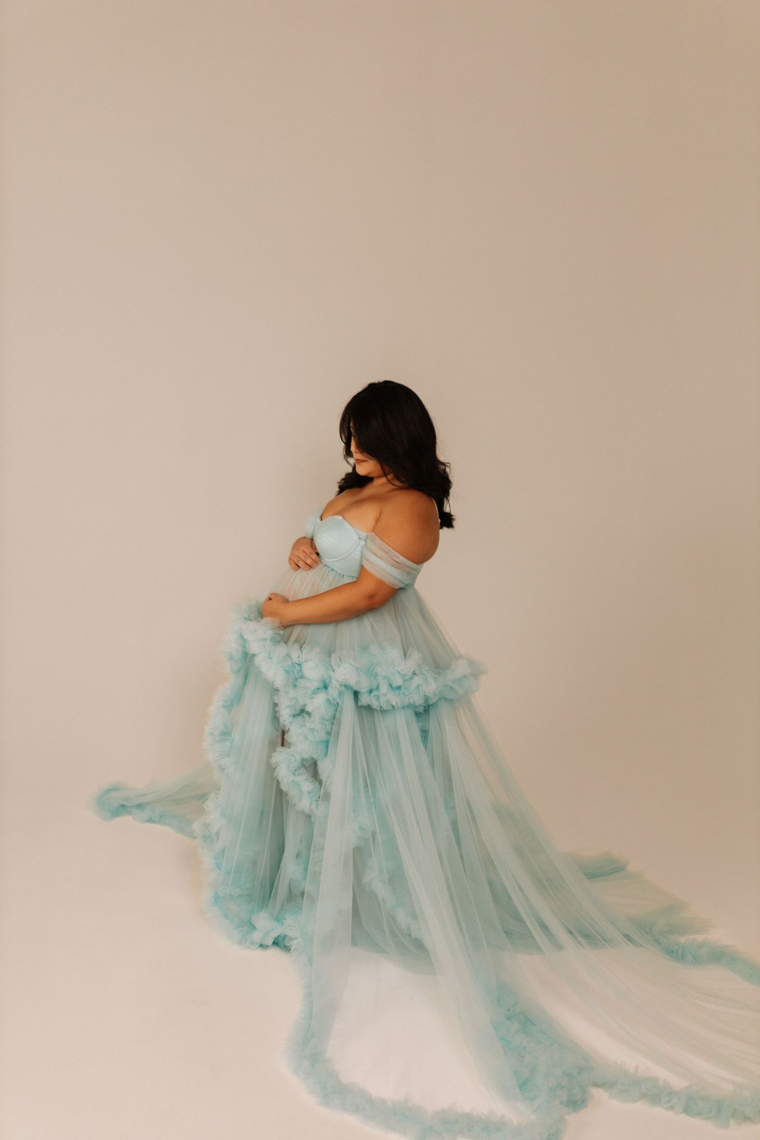 Ethereal maternity portrait in flowing mint green tulle gown.