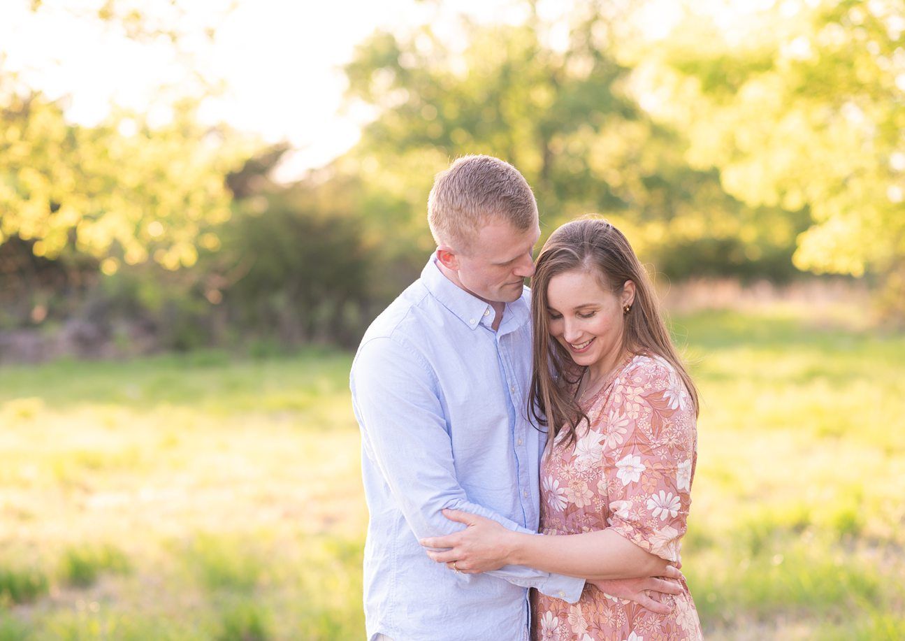 Family of 4 spring portrait session in light grassy field by Bartlesville photographer Kristi Bray