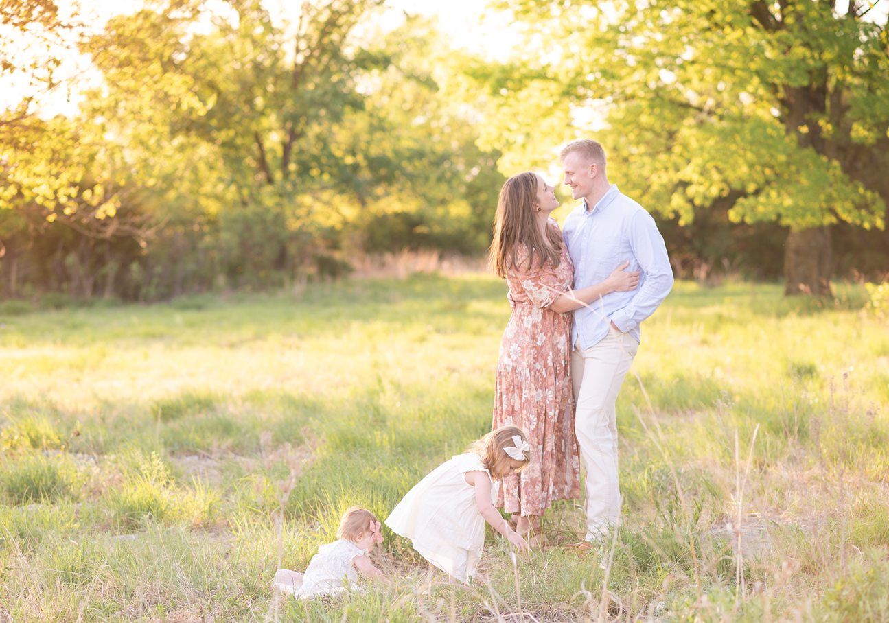 Family of 4 spring portrait session in light grassy field by Bartlesville photographer Kristi Bray