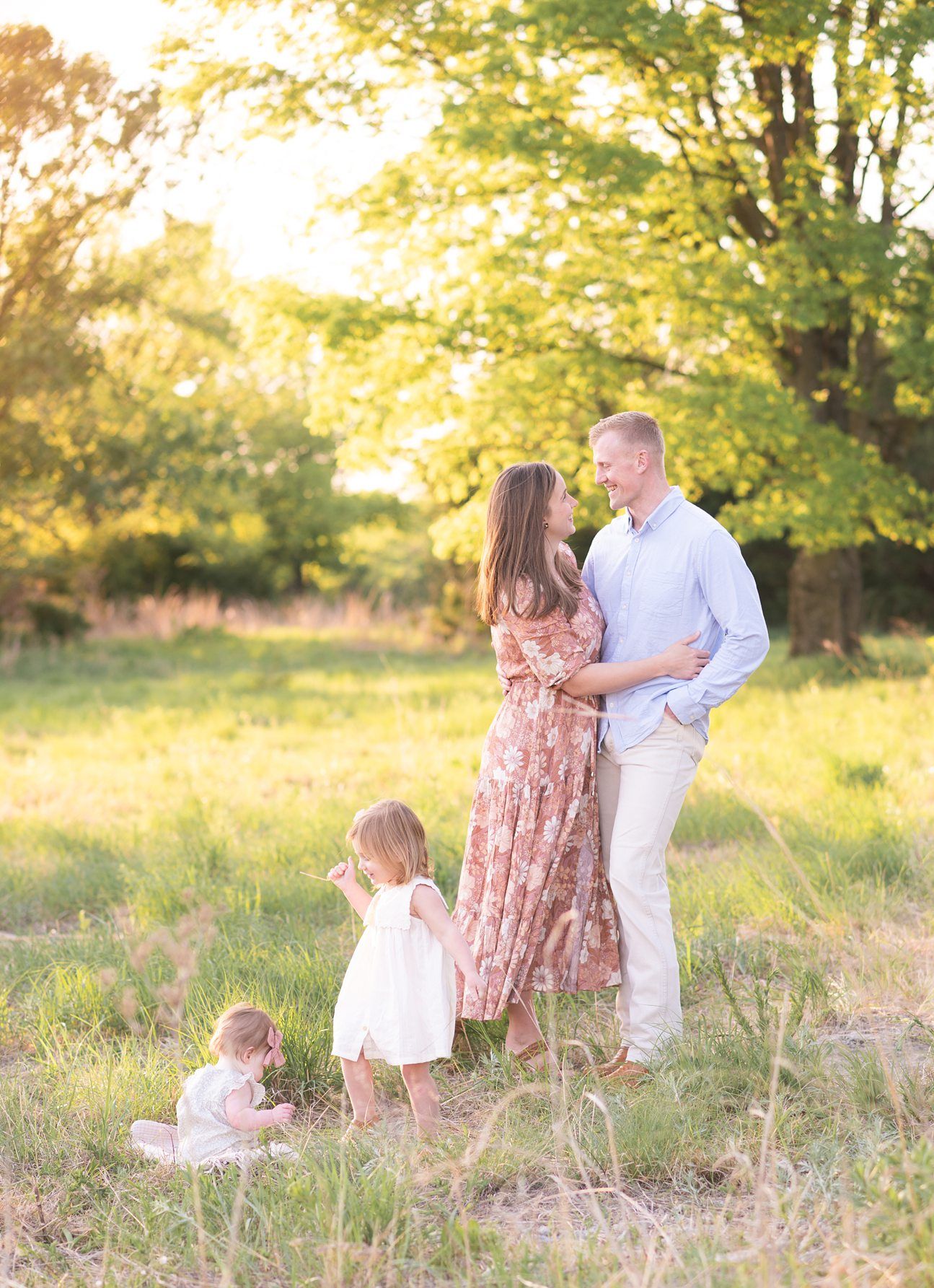 Family of 4 spring portrait session in light grassy field by Bartlesville photographer Kristi Bray