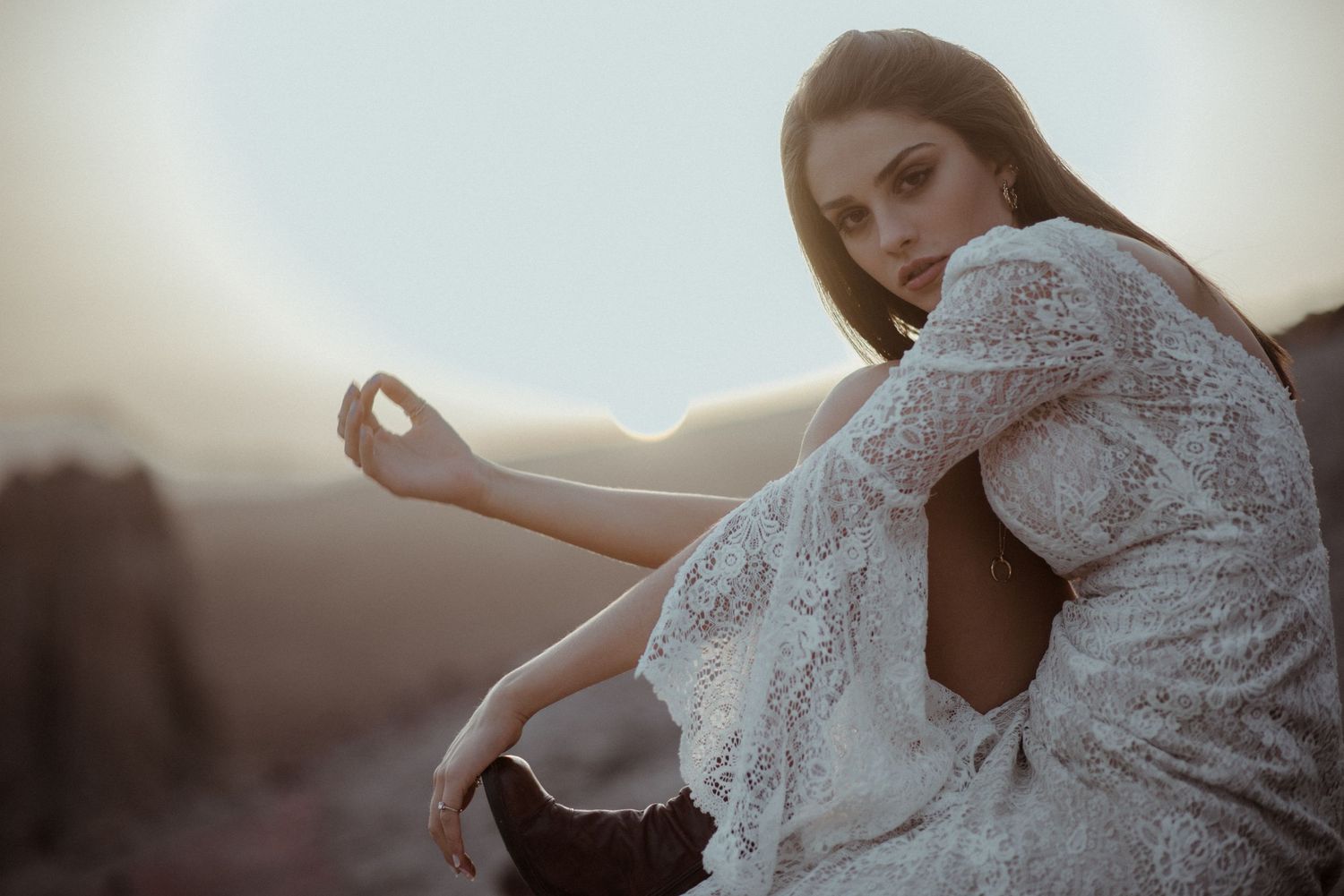 An ethereal fashion portrait at sunset featuring delicate white lace detailing.