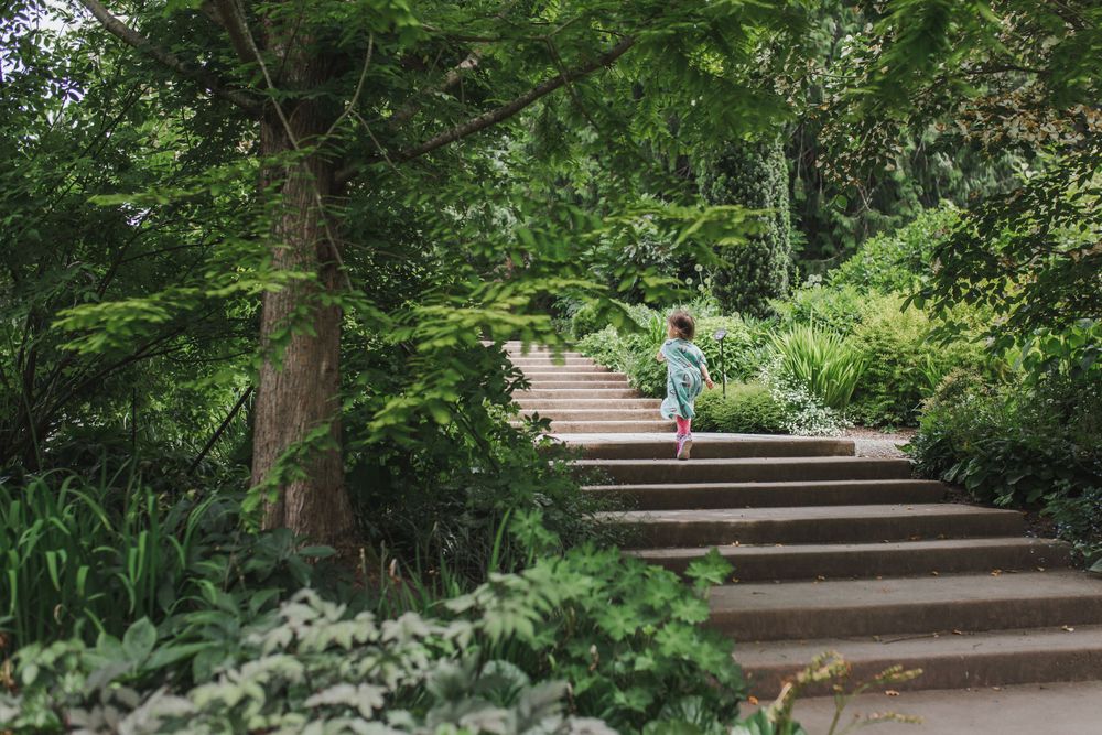 Girl running up the stairs at Bellevue Botanical Garden in the spring.