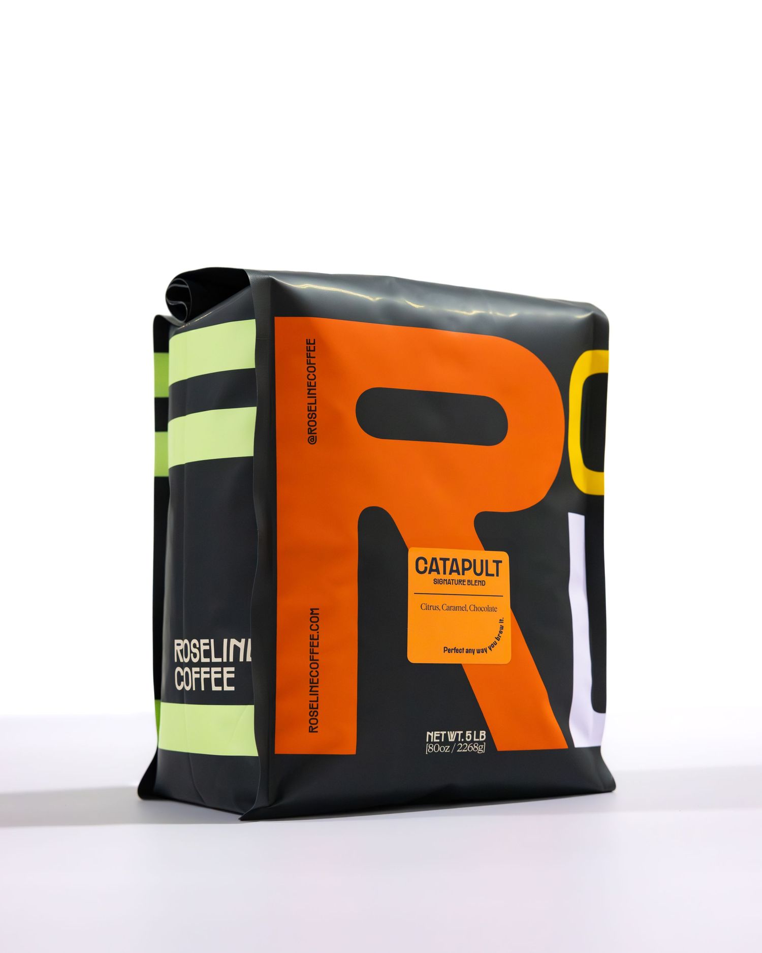 Orange and black coffee bag with bold letterform design and neon yellow accents against white background.