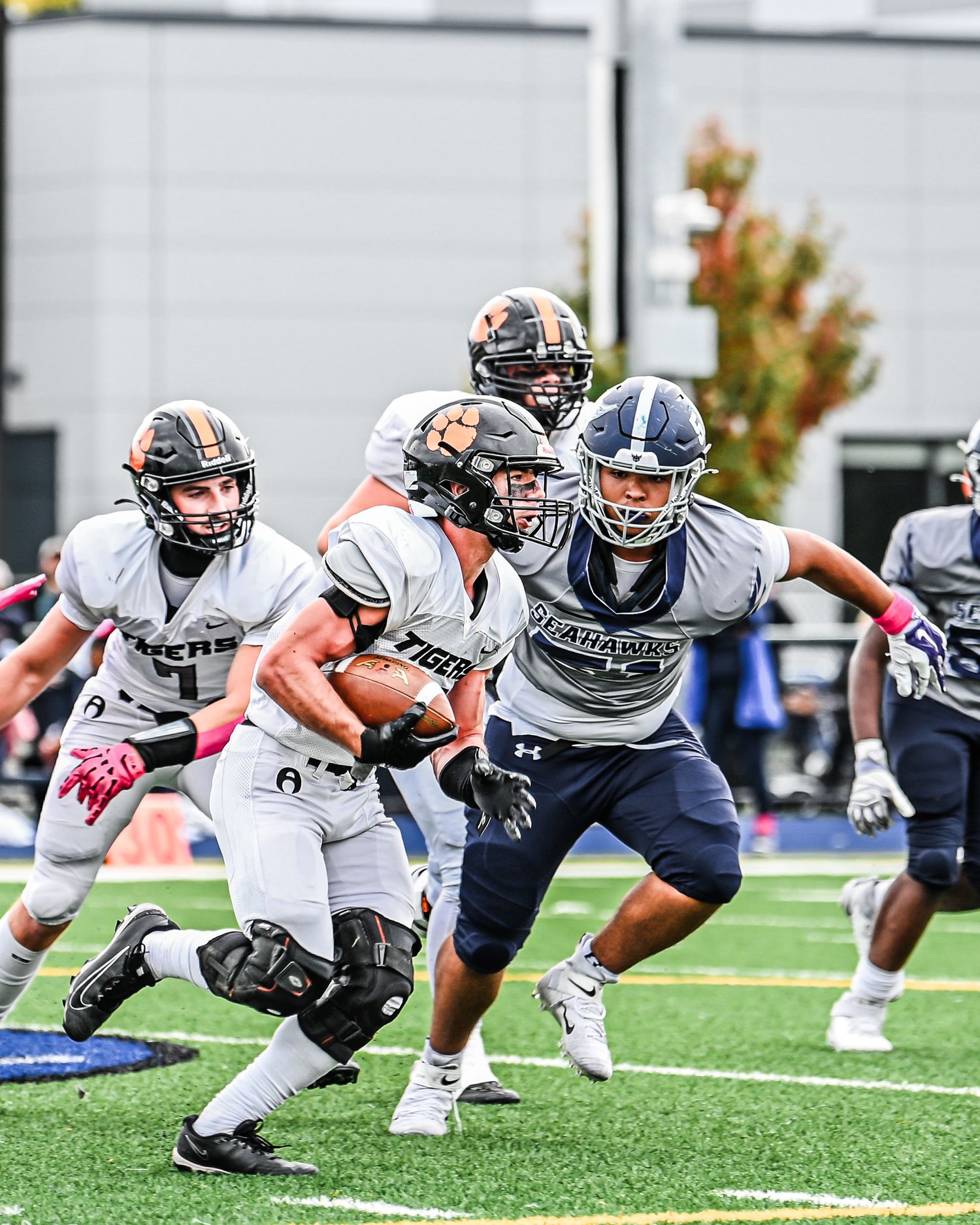 Akron and Maritime Football players line up in a three-point stance on the field. Buffalo ny sports photographer, forge city sports media