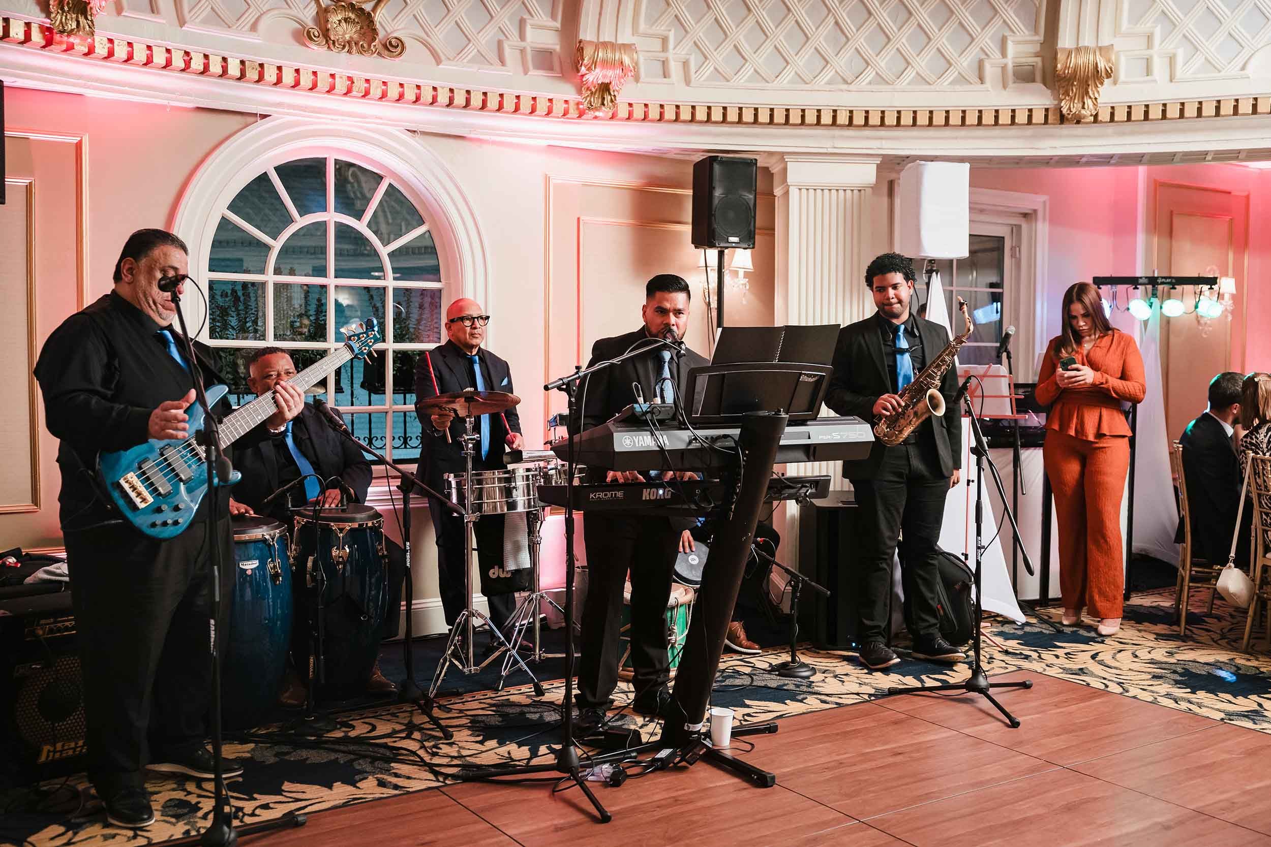 Full Grupo Chevere band performing live music in the Dome Room at the Lenox Hotel during a Boston wedding reception.
