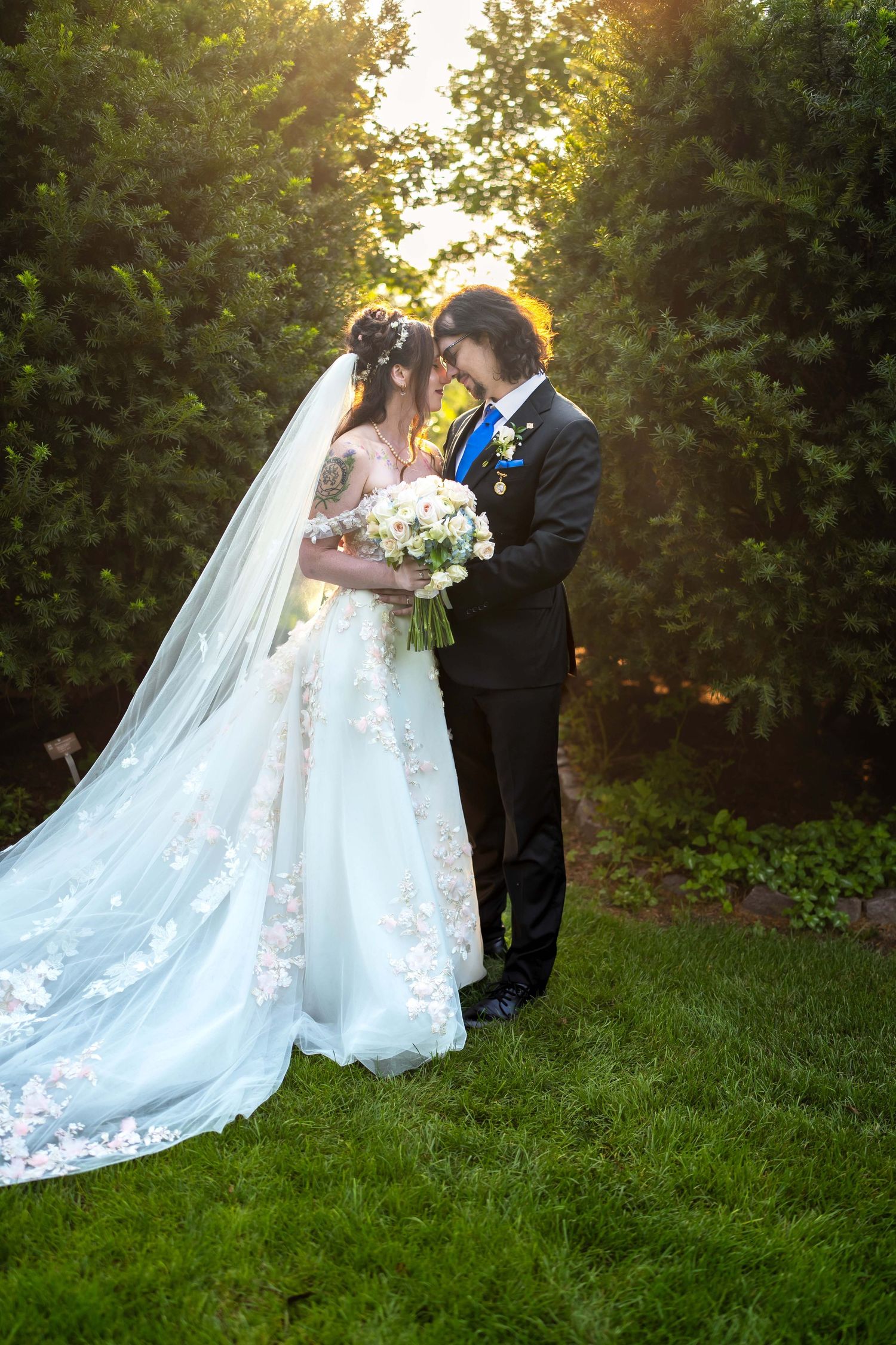 Bride  groom share romantic moment in garden at Toledo Zoo Wedding Venue