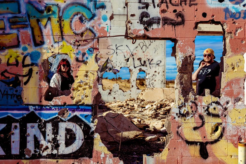 Colorful graffiti art wall with abstract designs used as a portrait backdrop by Zeus Holbrook Wedding Photographer