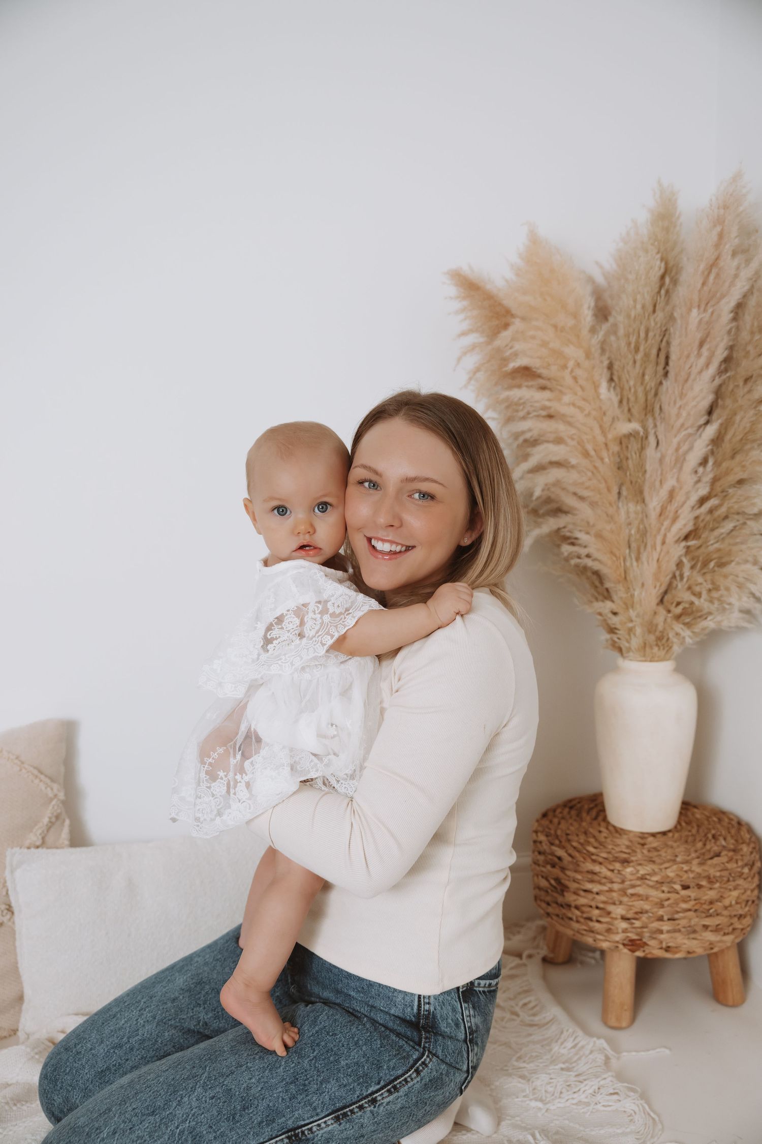 A cozy indoor photoshoot featuring pampas grass decor and casual styling in natural light.