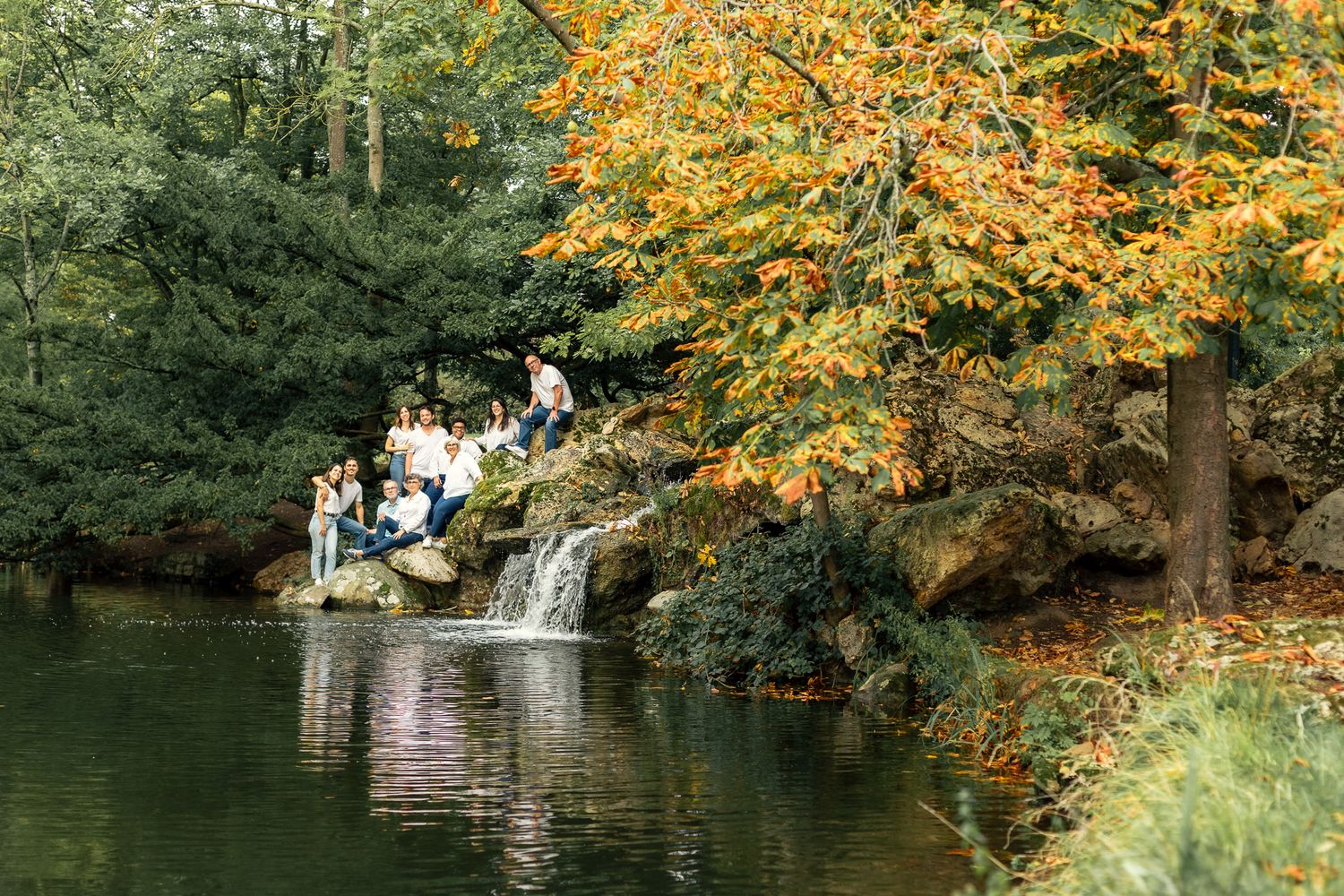 famille posant devant une cascade dans un parc au Vésinet lors d’une séance photo