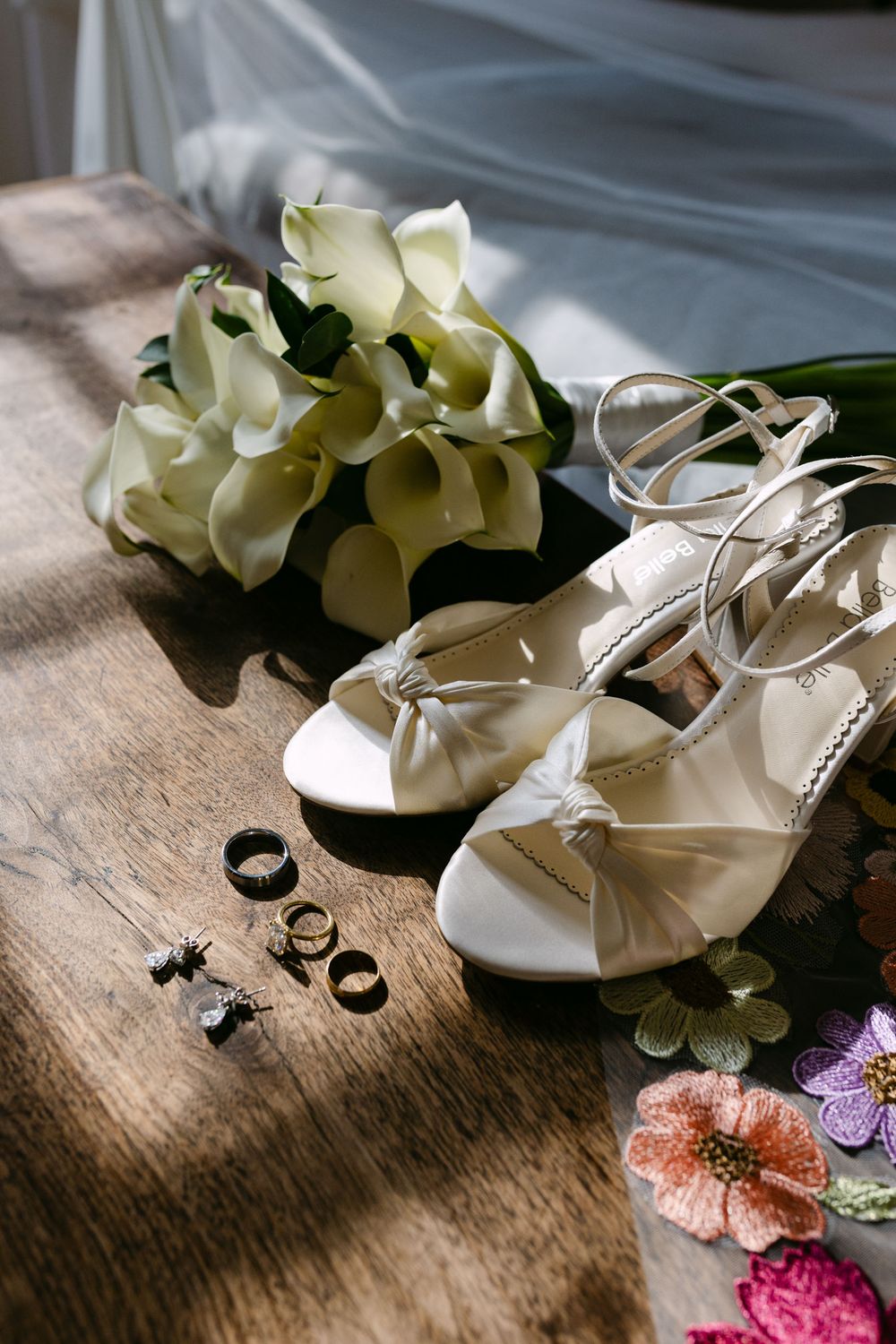 Bride wedding details with shoes, bouquet and rings in soft natural light at Quinta Nova do Hespanhol Lisbon