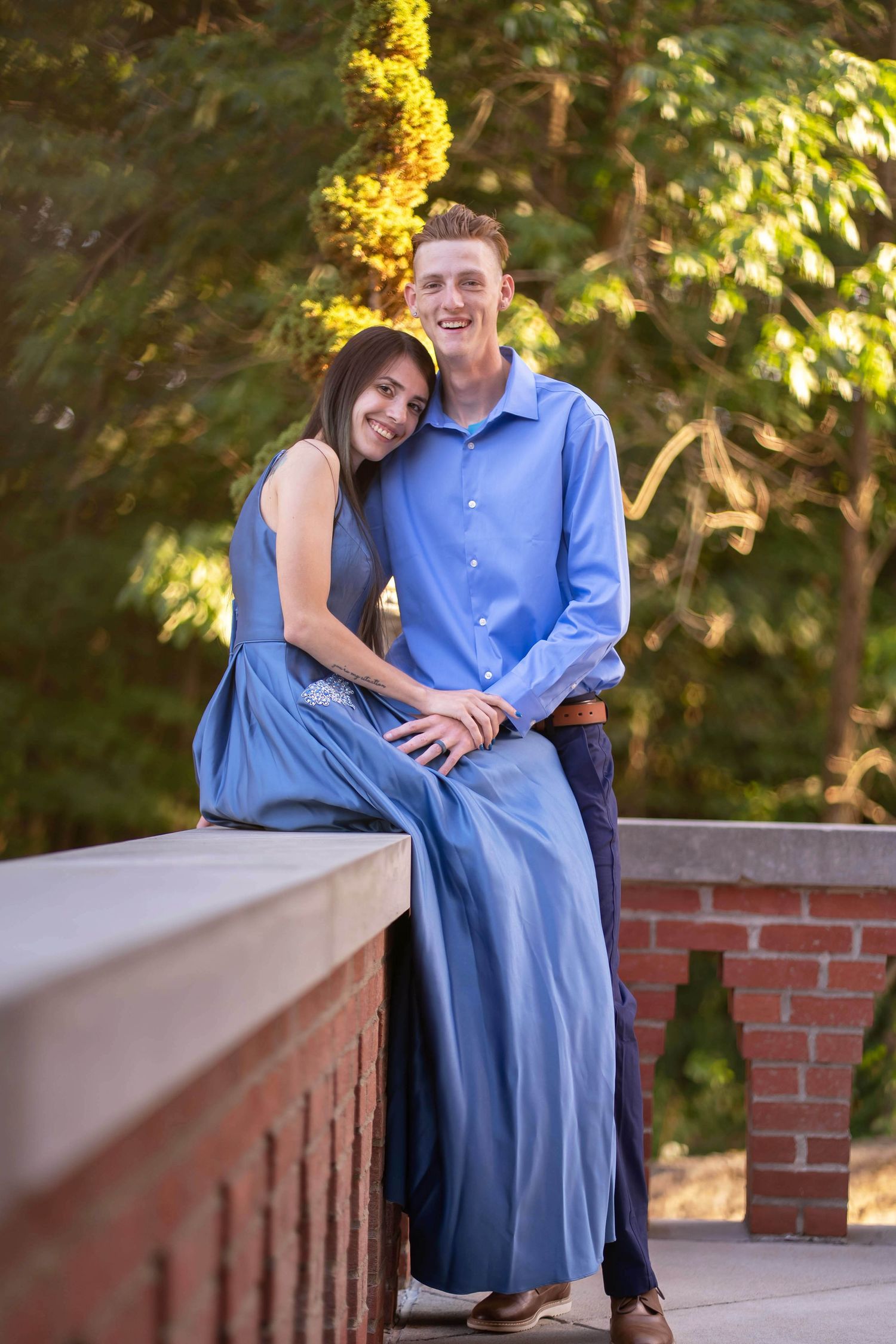 A romantic couple photographs an intimate moment outdoors during an engagement session