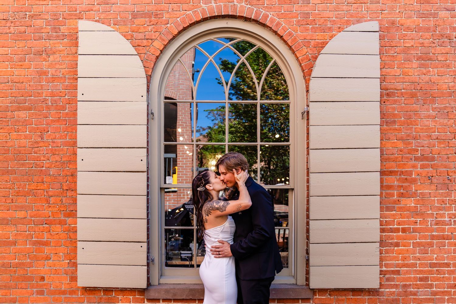 Just married couple kissing in Salem, Massachusetts after their ceremony.