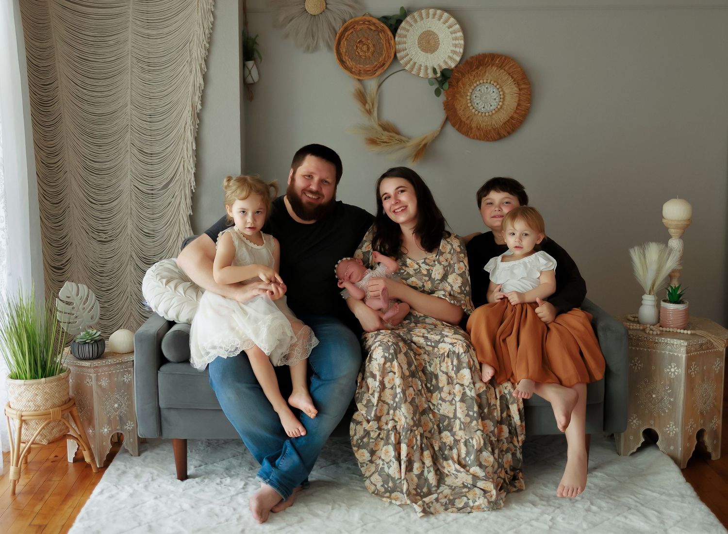 A family shares joyful moments together while sitting on a couch in a warm, intimate setting.