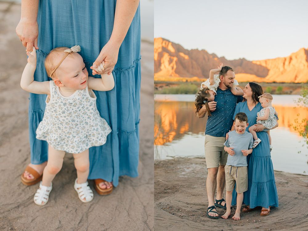 Family photo session at a desert lake, mom in blue dress with toddler girl, dad hugging wife and son against red rock mountains.