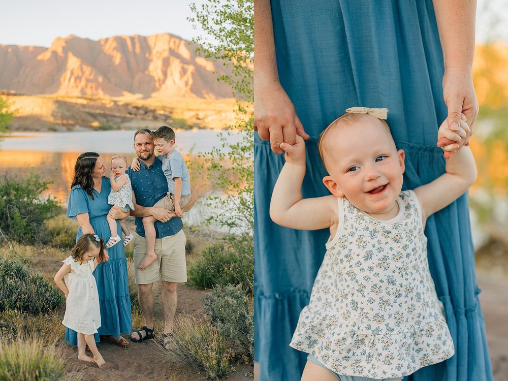 Family in coordinating blue outfits poses near a lake with mountain backdrop, while baby girl smiles holding mother's dress.