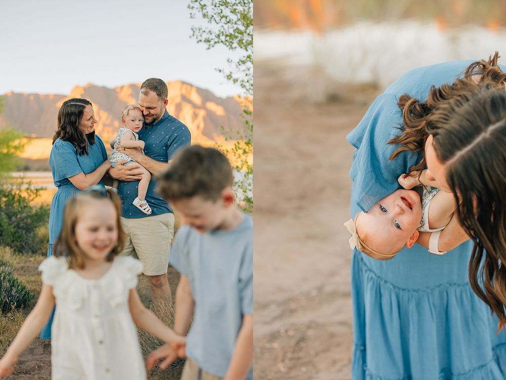 Family of four poses outdoors at golden hour near rocky desert landscape, parents holding toddler while daughter smiles.