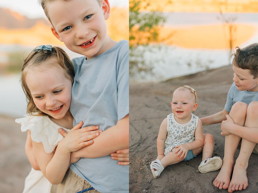 Two young siblings share a joyful hug outdoors, with a boy embracing his smiling little sister near a sunlit lake.