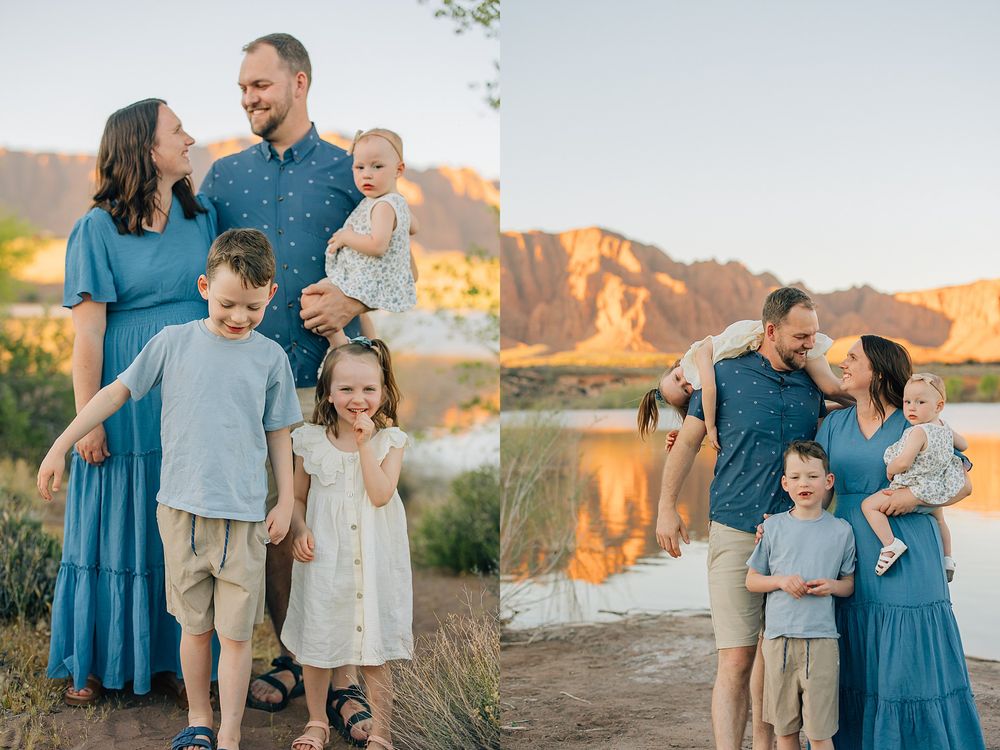 A happy family of five poses outdoors near a river with red rock cliffs, wearing coordinated blue and white outfits.