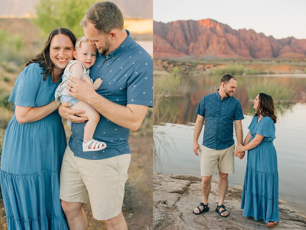 Family portrait with parents in blue outfits holding baby by a lake with red rock mountains at sunset.
