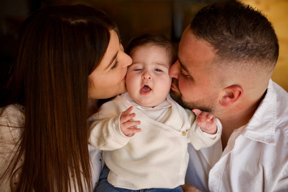 Parents embrassant leur bébé pendant une séance photo famille à Aix-en-Provence, instant d’amour et de complicité