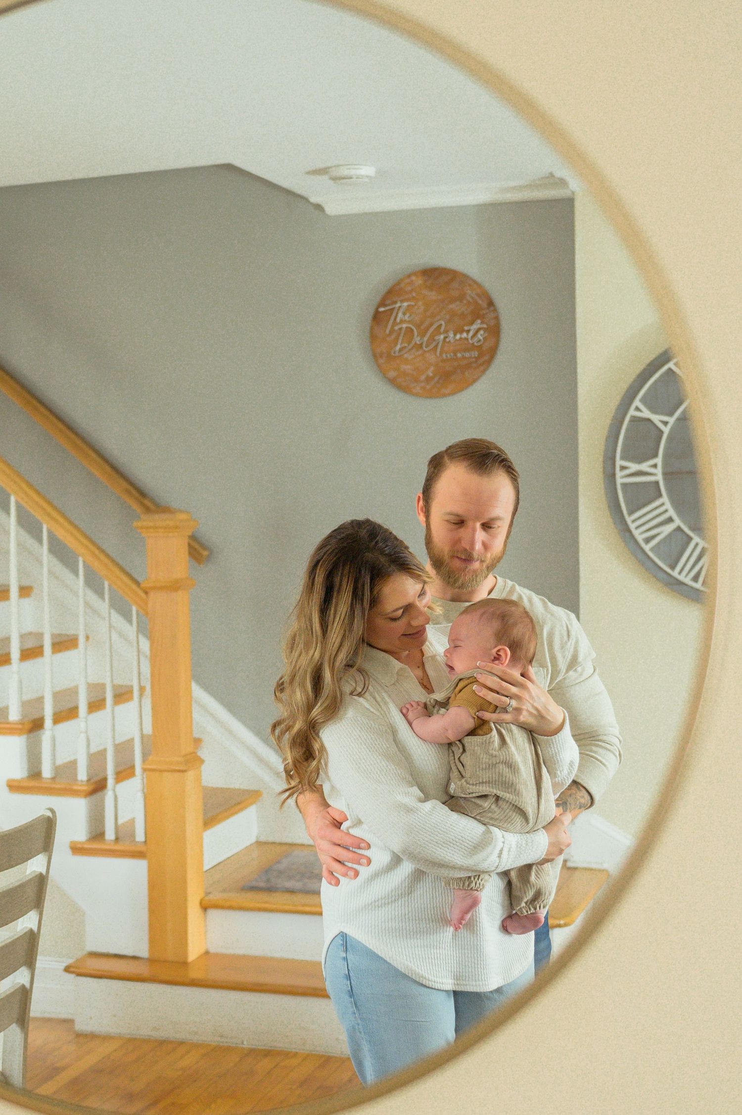A series of intimate moments captured through a circular frame showing a couple in white sweaters by wooden stairs.
