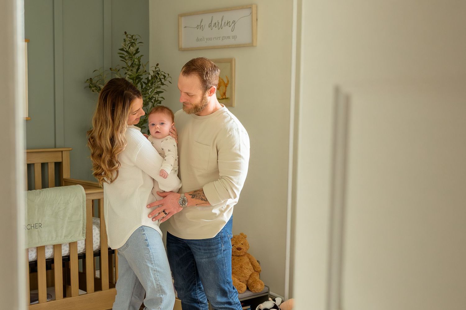 A parent and child share a tender moment while playing together in a bright, cozy home interior.