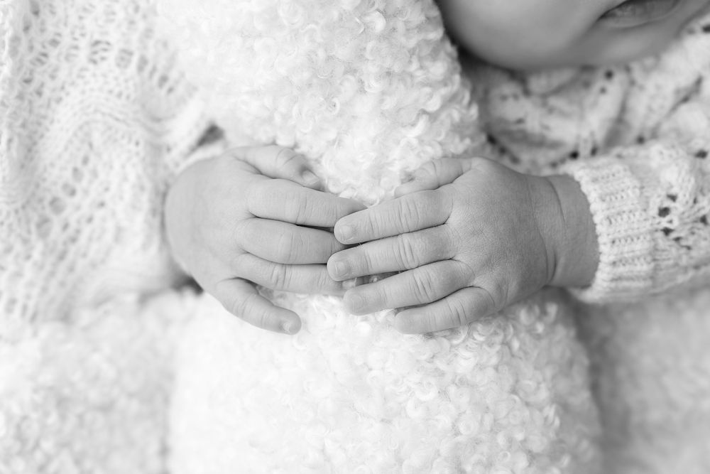 A series of black and white close-up photos showing gentle hands touching and embracing in an artistic style.