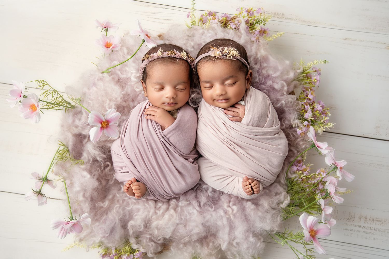 Sleeping newborn baby wearing delicate lace dress rests peacefully in vintage-style photography session.